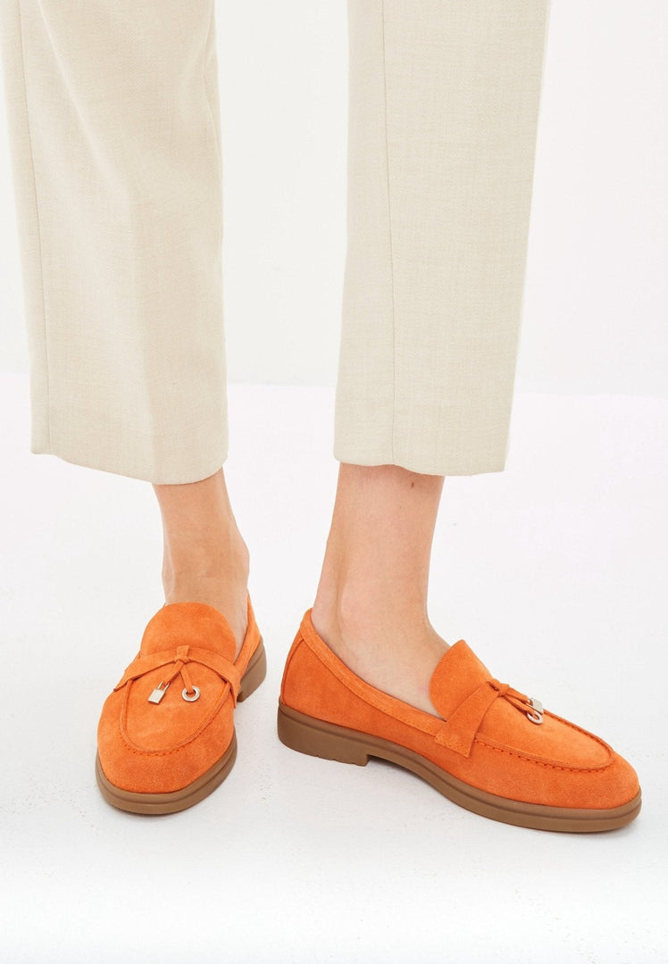 A trendy pair of men's classic loafers in stylish orange color with a flat sole, perfect for fashion-forward individuals looking for quality footwear.