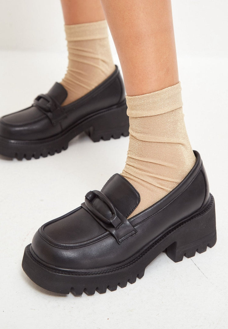 A stylish collection of women's shoes including leather loafers, classic black heels, block heel shoes, and black leather loafers for women.