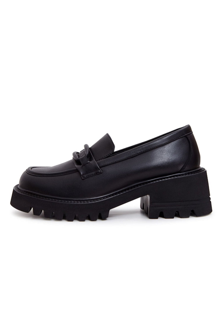 A stylish collection of black leather shoes including leather loafers, classic black heels, and block heel shoes for women.