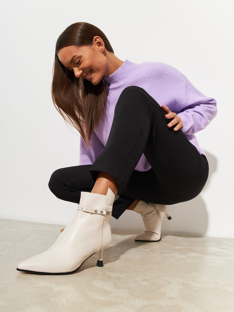 A pair of stylish high-heeled leather ankle boots, perfect as fashionable leather booties for women's heeled boots.