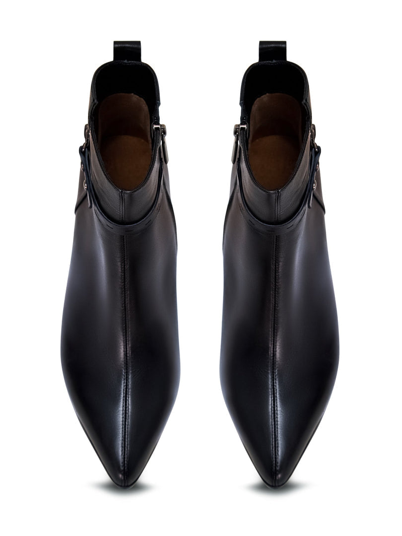 A close-up image of fashionable high-heeled leather ankle boots, a stylish choice in women's heeled boots and leather booties.