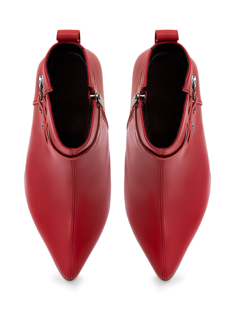 A pair of fashionable high-heeled leather ankle boots for women, featuring stylish leather booties design.