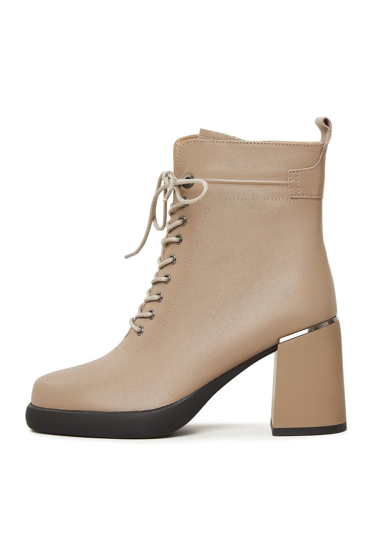 A pair of fashionable high-heeled beige ankle boots for women - the perfect classic addition to any outfit.