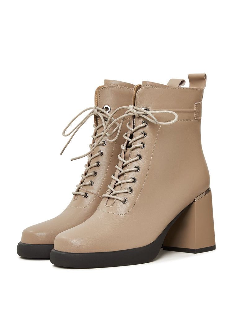 A stylish pair of classic beige high-heeled ankle boots for women, a must-have in trendy footwear fashion.