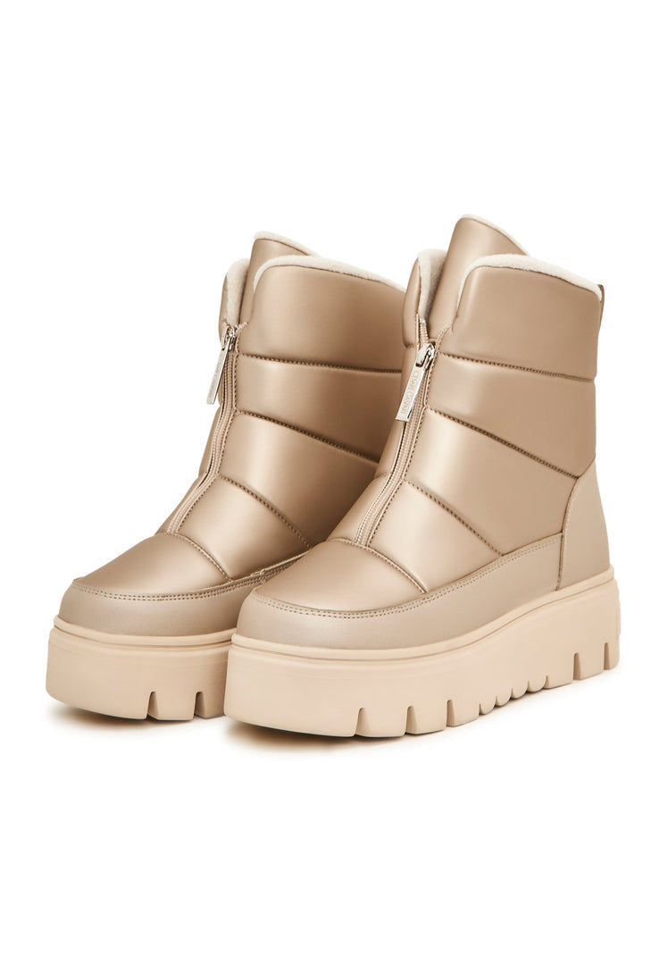 A pair of stylish beige winter boots, perfect for snowy days and elegant cold weather outings.