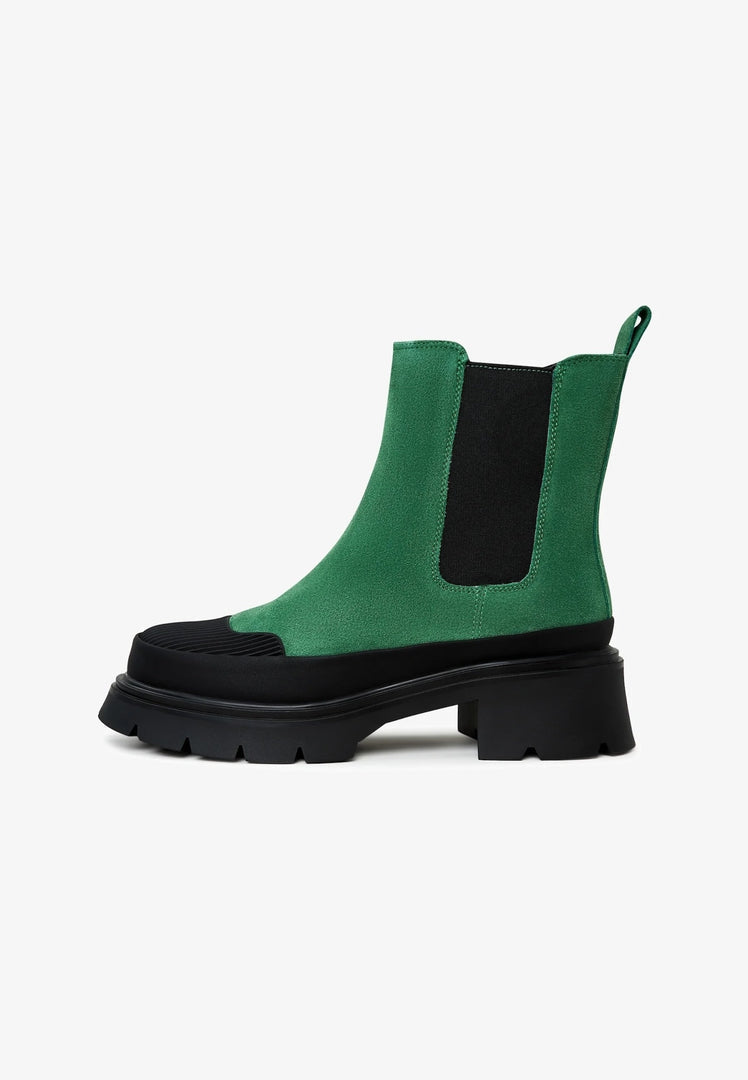 A pair of stylish green urban platform ankle boots, fashionable and trendy ankle boots for women, the perfect choice in fashionable urban footwear.