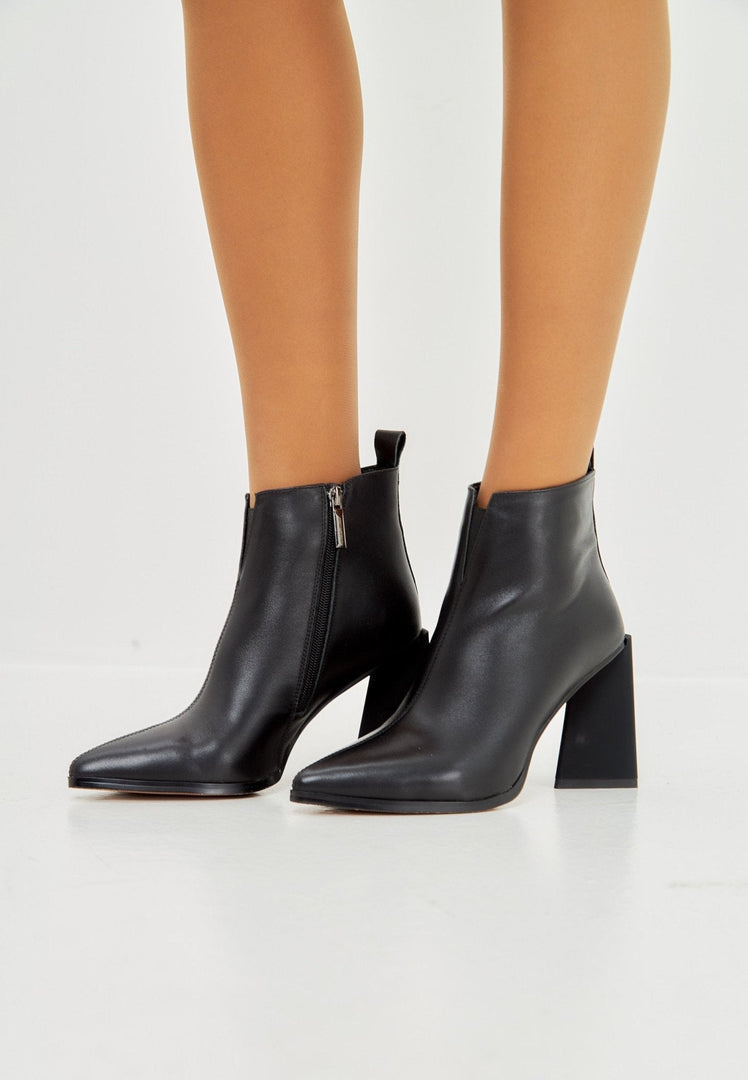 A stylish pair of black pointed toe ankle boots with block heels, perfect for any outfit.