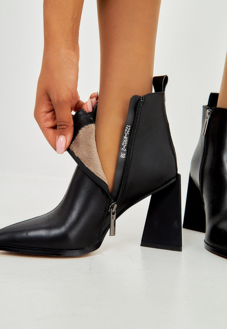 A chic pair of black pointed toe ankle boots with a stylish block heel, made from leather material.