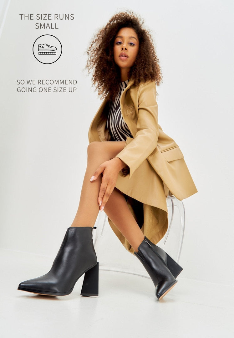 A stylish pair of black leather pointed toe ankle boots with block heels for a chic and trendy look.