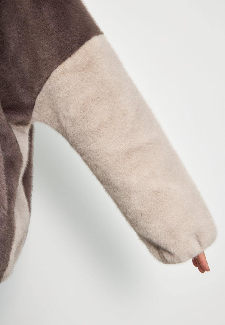 A trendy brown faux fur hooded jacket called Reyna, a perfect addition to women's fashion.