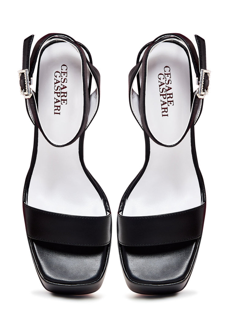 A stylish pair of elevated black sandals, perfect for adding a touch of elegance to any outfit.