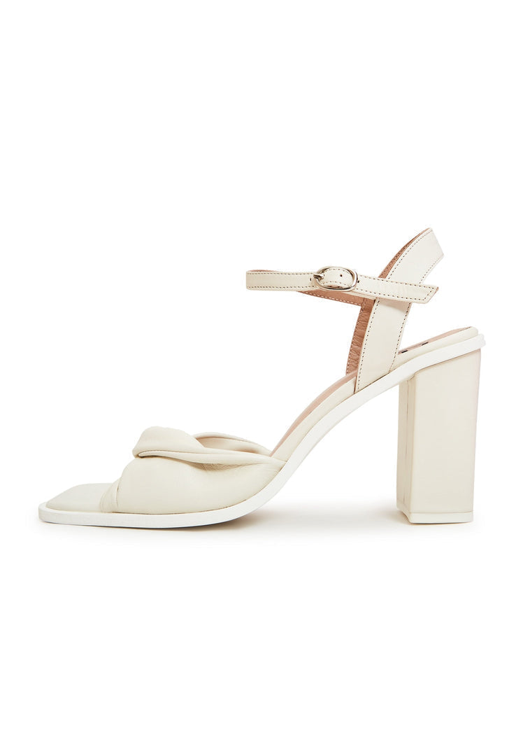 A stylish pair of women's timeless beige block heels, the perfect classic and fashionable choice for any outfit.