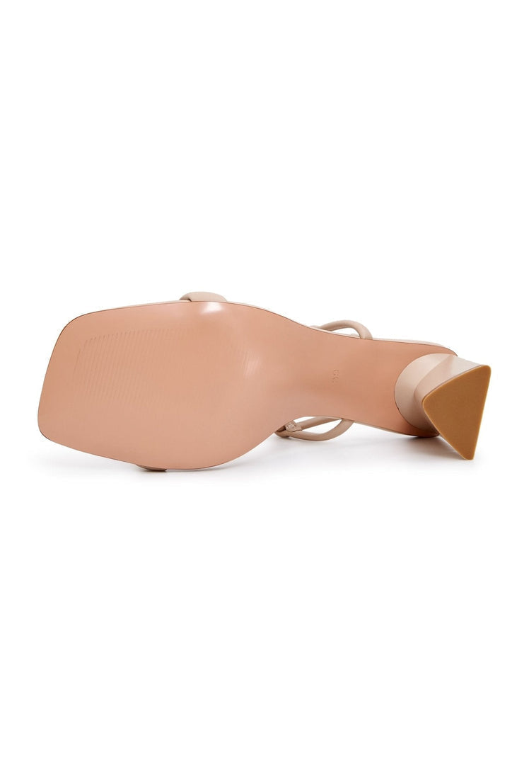 A pair of elegant beige heels, perfect for any occasion. These stylish women's dress shoes exude high-end designer footwear, adding a touch of elevated elegance to your outfit.