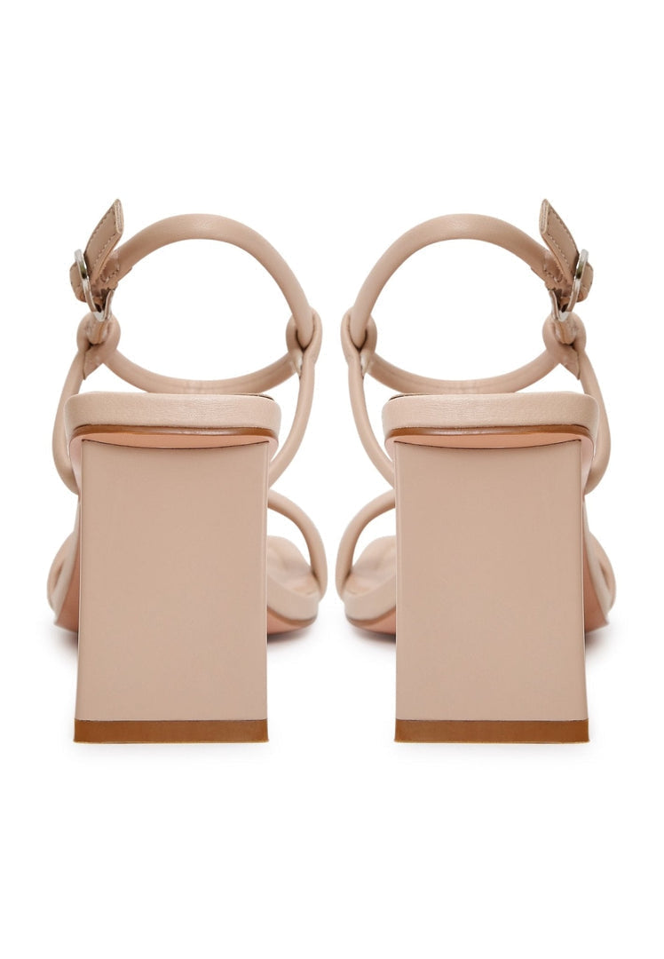 A pair of stylish beige heels, perfect for women's dress shoes, showcasing elevated elegance footwear from high-end designer collection.