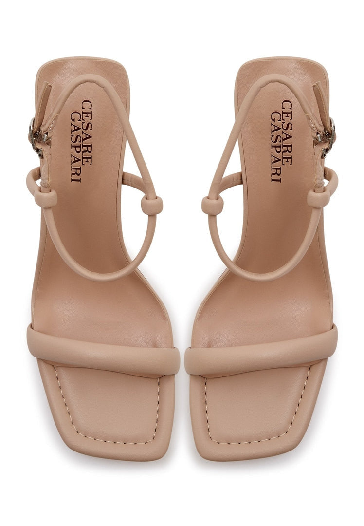 Pair of elegant beige women's dress shoes, featuring stylish heels for elevated elegance - high-end designer footwear.