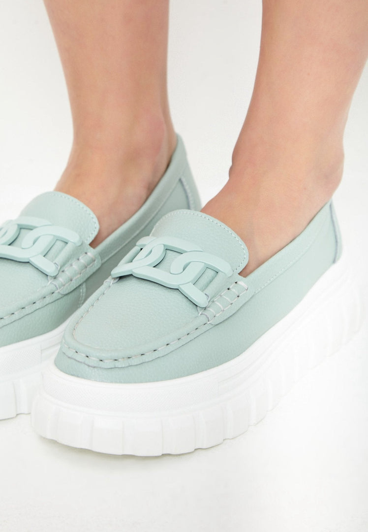 A pair of stylish blue platform loafers, made of quality leather, perfect for urban footwear fashion.