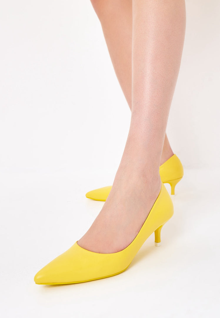 A pair of luxurious yellow pumps, the epitome of elegant footwear and designer heels, representing high-end shoes.