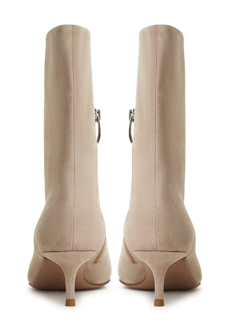 A pair of stylish Regina beige ankle boots, perfect for women who love classic fashion and designer footwear trends.