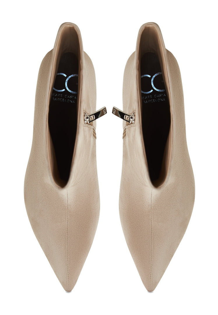 A stylish pair of classic ankle boots in beige, known as Regina boots, for women - fashionable designer footwear.