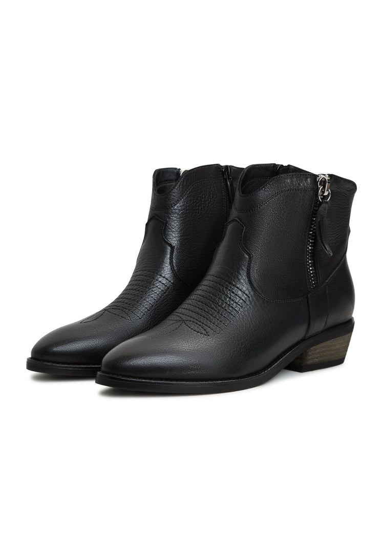 A close-up image of black leather Vicky cowboy boots, showcasing intricate Western-style details and handmade craftsmanship.