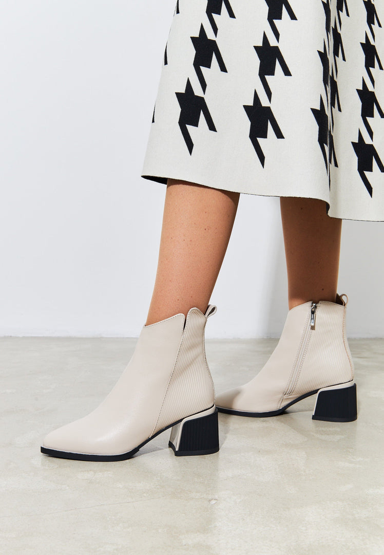 A pair of stylish and comfortable women's beige ankle boots, perfect for fashion-forward casual looks.