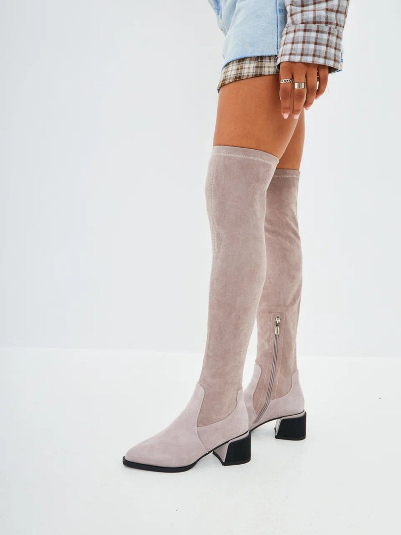 A trendy pair of beige suede over-the-knee boots, the perfect chic addition to your fashion footwear collection.