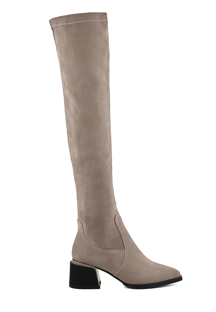 A fashionable pair of beige suede over-the-knee boots, the epitome of chic footwear fashion.