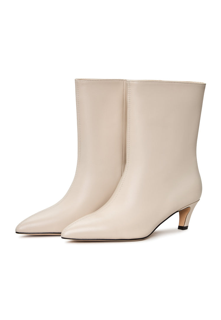 A pair of trendy white kitten heel ankle boots, perfect for stylish women looking for the latest fashion in dolly ankle boots.