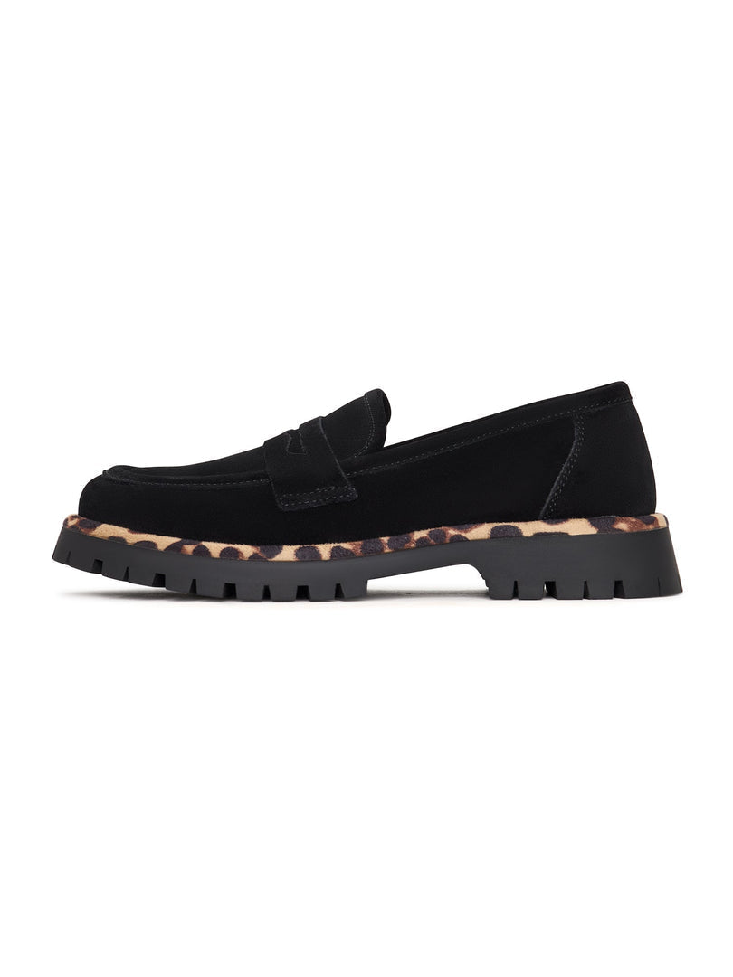 A pair of chic black loafers with a chunky sole, known as Lily black loafers, a stylish and fashionable choice in footwear.