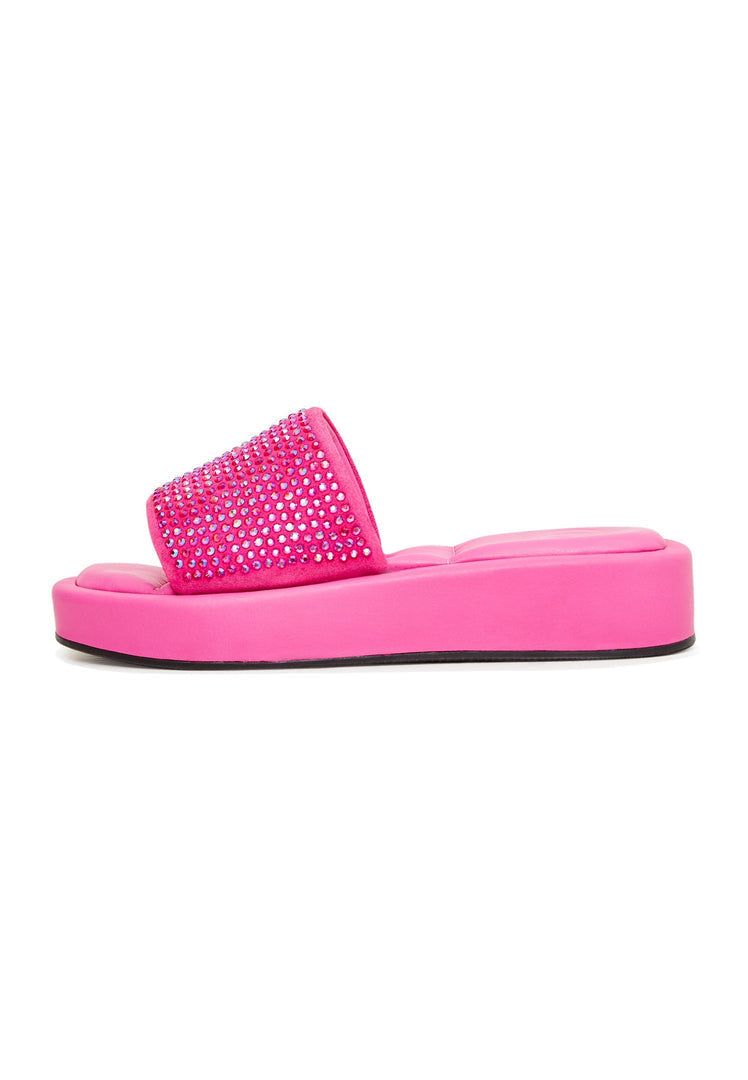 A pair of eye-catching fuchsia jewel platform mule shoes for women, adorned with embellishments making them a stunning choice for statement footwear.