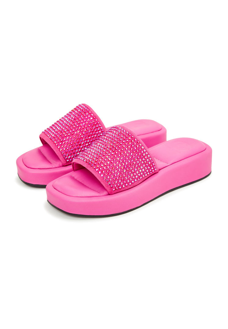 A pair of striking fuchsia jewel platform mule shoes for women, featuring glamorous embellishments, making them the ultimate statement footwear.