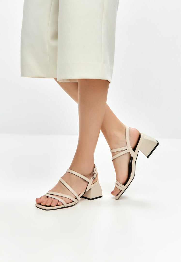 A stylish pair of beige block heels sandals known as Maria sandals for women, perfect for adding a trendy touch to any outfit.