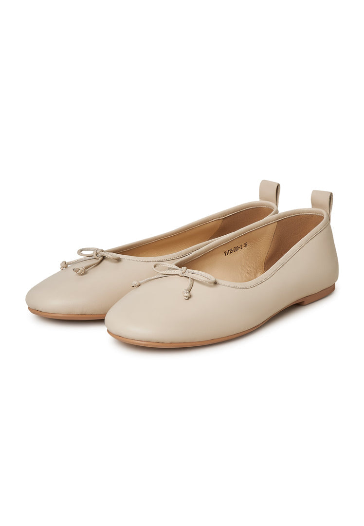 A pair of elegant ivory leather ballerinas, perfect for women seeking stylish leather flats, ivory ballet flats, leather slip-on shoes, or chic ivory dress shoes.