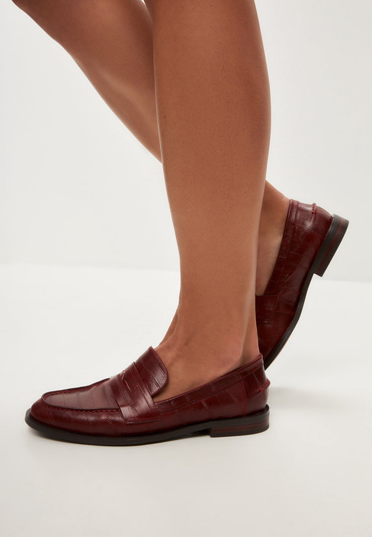A stylish image of women's leather loafers and block heeled shoes in fashionable Bordeaux color.