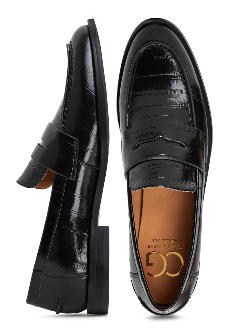 A stylish pair of black leather block heeled loafers, perfect for women's footwear fashion.