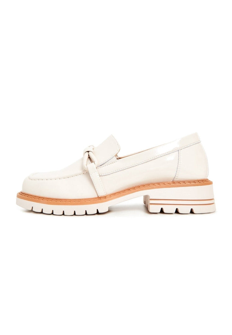 A chic pair of beige block heels loafers for women, blending fashionable heels with comfortable loafers for a stylish look.