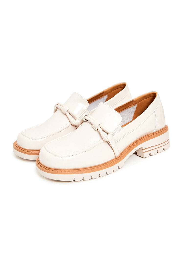 A pair of fashionable beige block heels loafers, perfect for women looking for stylish and comfortable footwear.
