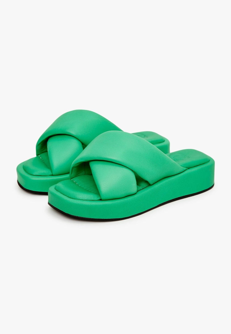 A stylish green leather platform mule shoe that combines fashion and comfort.