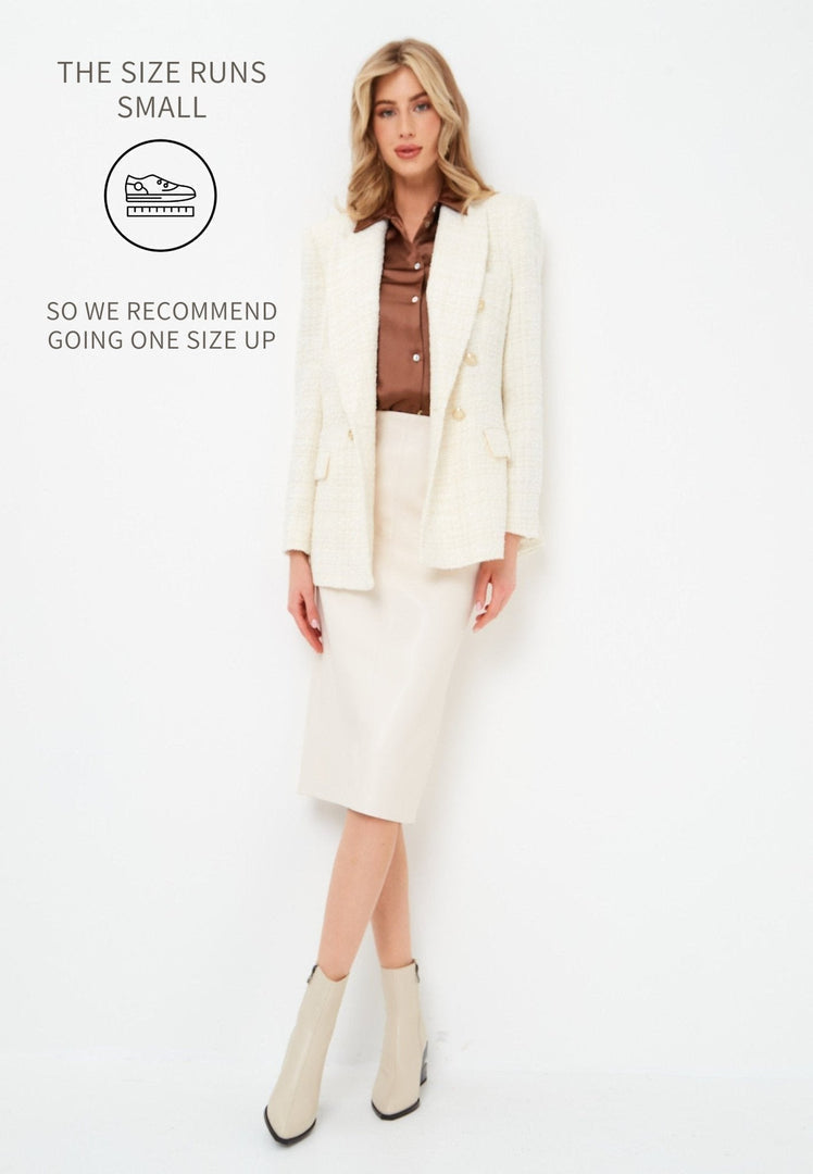 A trendy pair of women's beige leather ankle boots with a fashionable block heel design, perfect for completing any outfit.