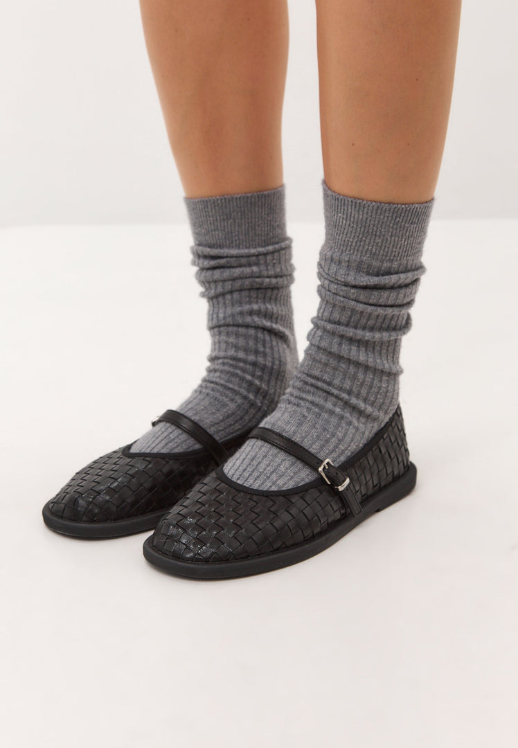 A stylish pair of black Women's Mary Janes, featuring woven elegance and perfect for a fashionable look.
