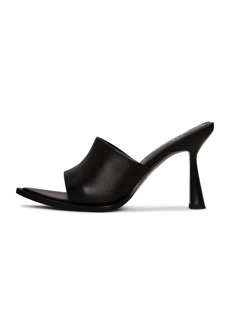 A pair of black minimalist heeled mules for women, a stylish choice in minimalist footwear.
