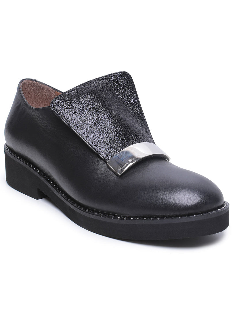 A pair of stylish men's leather slip-on loafers with metal accents, fashionable and versatile for any occasion.