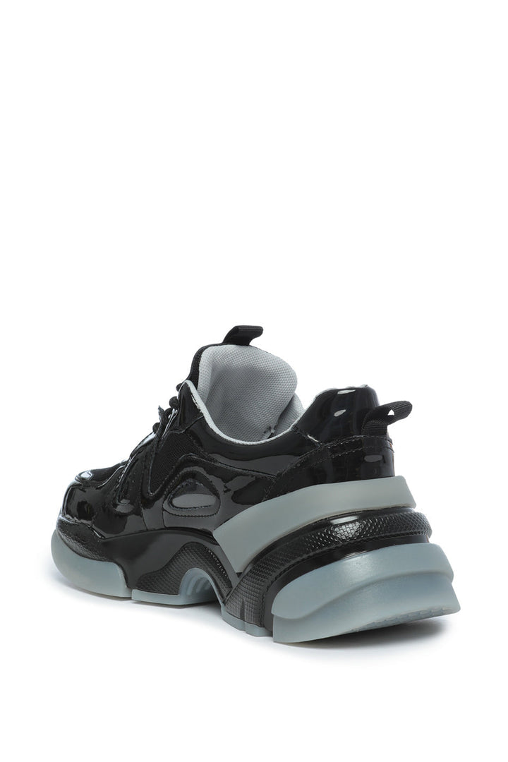 A fashionable pair of chunky sole, glossy platform sneakers that are perfect for a trendy and stylish look.