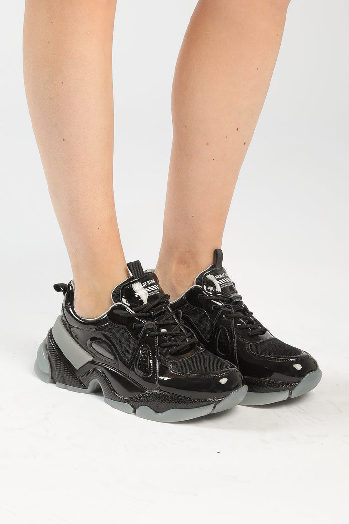 A stylish pair of platform sneakers with chunky soles and a glossy finish, perfect for anyone looking to stay on-trend with fashion-forward footwear.