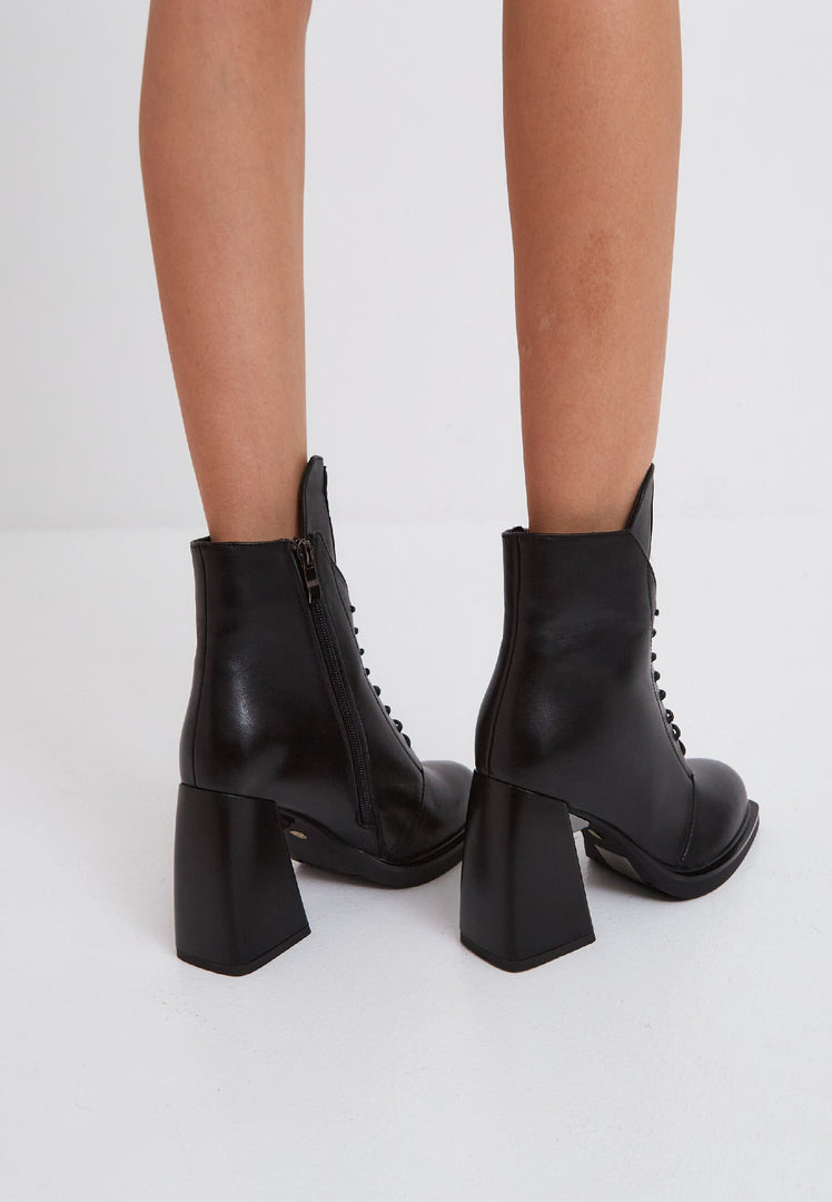 A stylish pair of black leather lace-up ankle boots known as Behati boots.