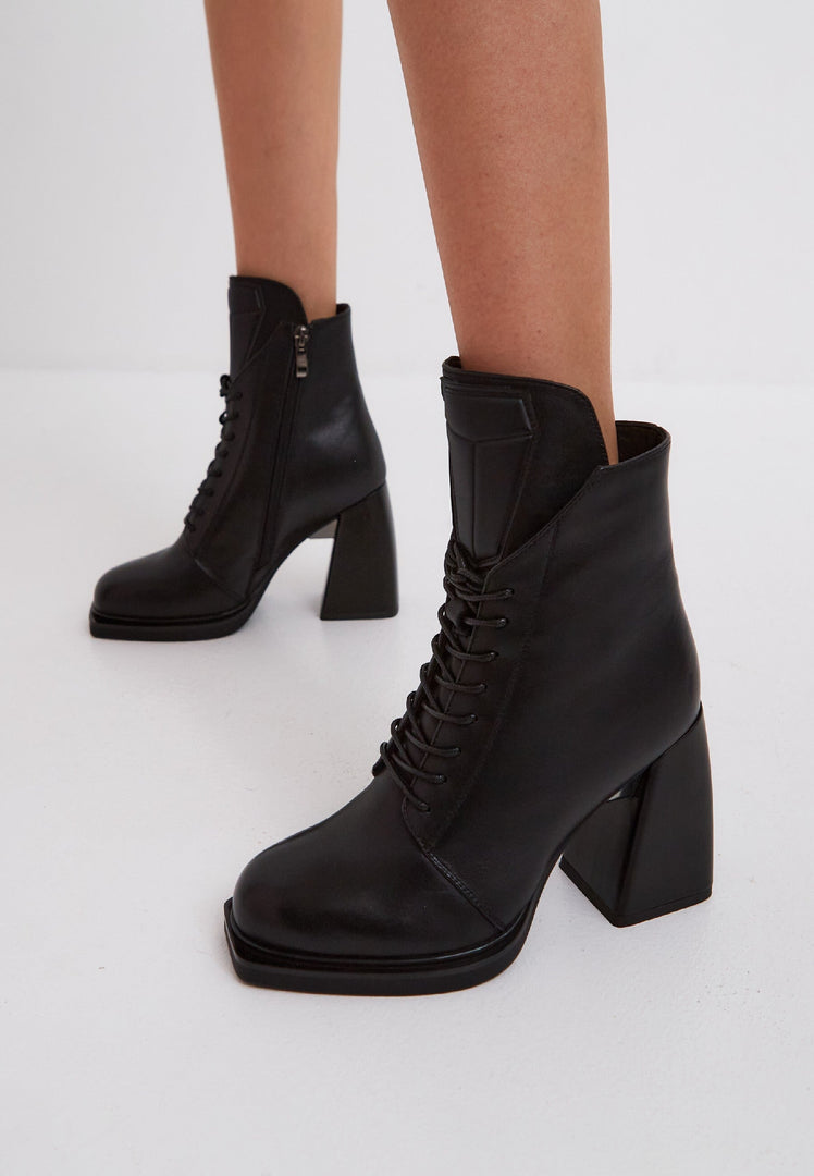 A stylish pair of black leather lace-up ankle boots, known as Behati black boots, perfect for any outfit.