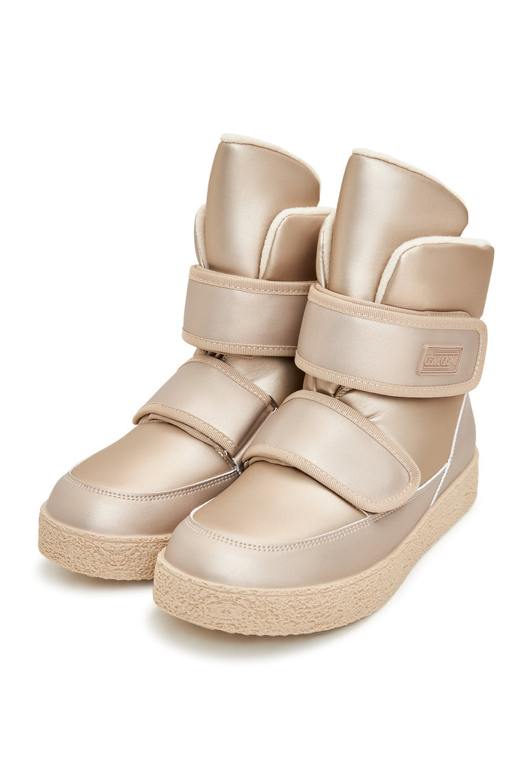 A pair of beige high-top winter boots with convenient Velcro straps, perfect for stylish and practical winter footwear.
