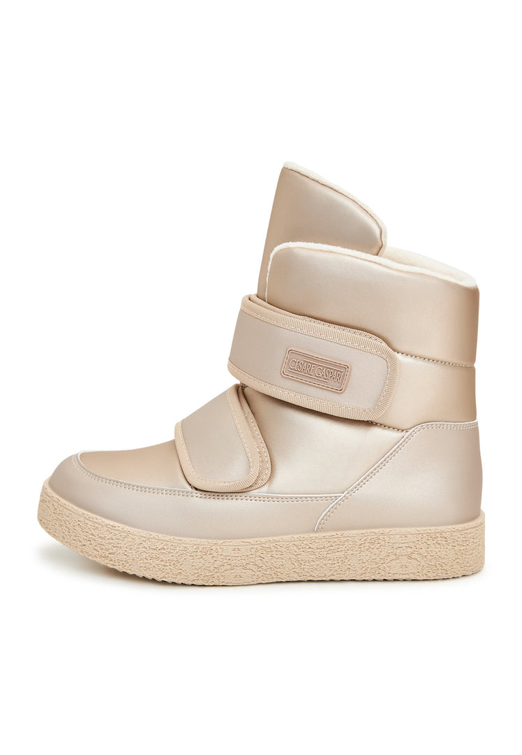A pair of beige high-top winter boots with velcro straps, ideal for snowy days and chilly weather, the perfect winter footwear choice.