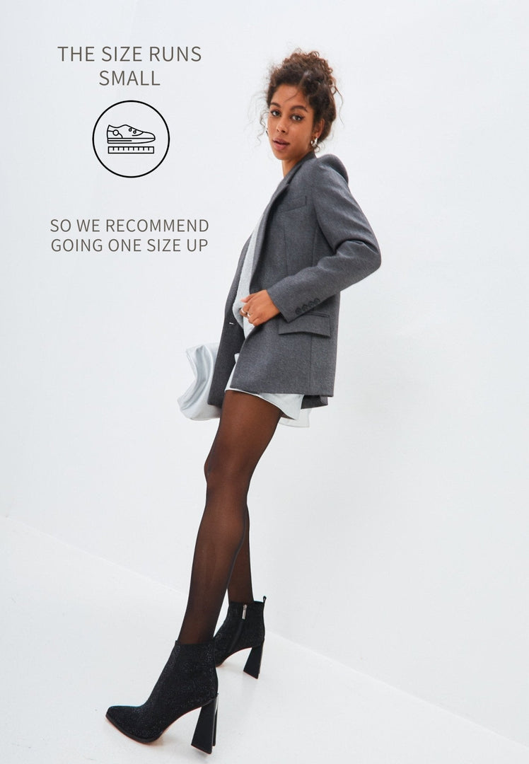 A trendy pair of pointed toe black suede ankle boots with a block heel, made of leather, perfect for a stylish look.