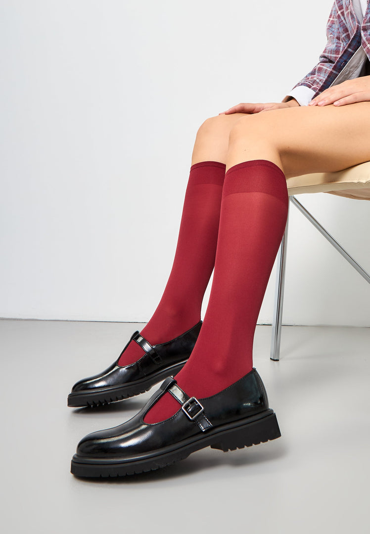 A stylish pair of women's patent black Mary Jane loafers, also known as MayJay loafers, featuring a classic Mary Jane style.